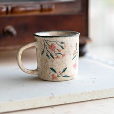 a coffee cup sitting on top of a counter