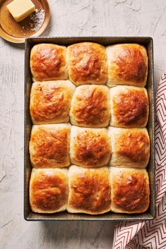 a baking pan filled with rolls on top of a table