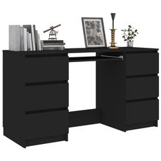 a black desk with books and pictures on it