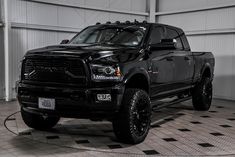 a large black truck parked in a garage