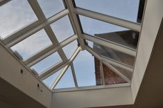 an open skylight in a room with brick walls