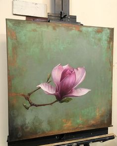 a painting with a pink flower on it in front of a green and brown background