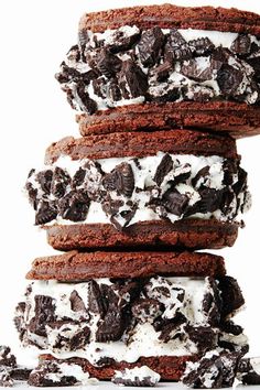 chocolate cookies and oreo cookies stacked on top of each other with white frosting