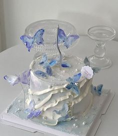 a white cake with blue butterflies on it