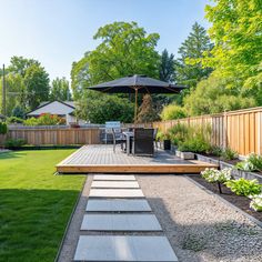 an outdoor patio with steps leading up to the deck and table, umbrella over it