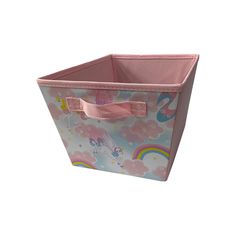 a pink storage bin with unicorns and rainbows on the side, sitting in front of a white background