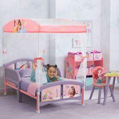 She'll drift off to sleep like a true Disney Princess in this canopy toddler bed by Delta Children. © Disney She'll drift off to sleep like a true Disney Princess in this canopy toddler bed by Delta Children. © Disney Easy assembly Uses a standard crib mattress (sold separately) Features two attached guardrails with low to the ground design at ideal kid-sized height Enables safe and easy access in and out of bed Colorful Disney Princess canopy creates a dream bedroom for your little one JPMA cer Disney Princess Bedding, Princess Canopy, Disney Princess Theme, Big Kid Bed, Princess Bed, Crib Toddler Bed, Toddler Beds, Princess Theme, Delta Children