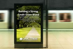 a sign in the middle of a train station that says building a strong credit union brand