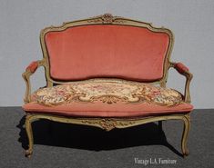 an old fashioned couch with red velvet upholstered on it's back end