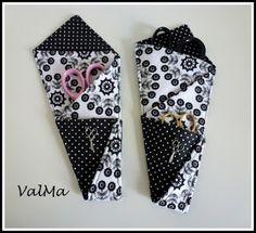 two black and white bags with pink scissors in them