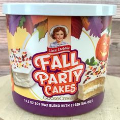 an ice cream container with fall party cakes in it on top of a wooden table