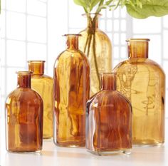 several brown glass vases sitting next to each other