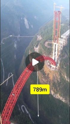 an aerial view of a large red structure in the middle of a mountain with a yellow arrow pointing to it