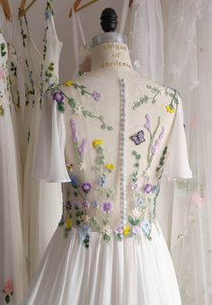 a white dress with colorful flowers on it