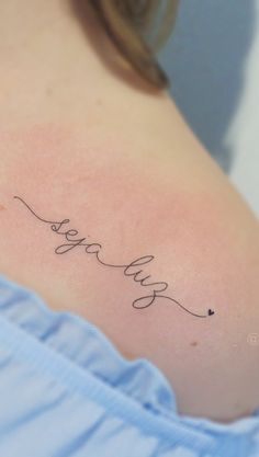 a woman's back shoulder with the word fearless written in cursive writing