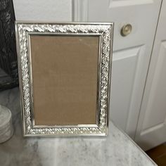 a silver frame sitting on top of a marble counter