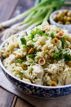 a bowl filled with rice and vegetables on top of a table