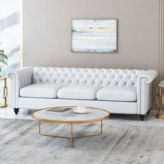 a living room with a white couch and coffee table