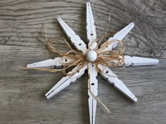 a snowflake made out of wood and string