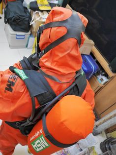 an orange life jacket is attached to the back of a man's body