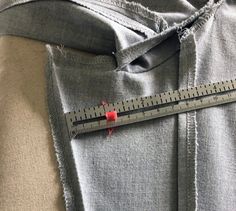 a measuring tape on the back of a pair of jeans