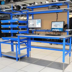 there are many computers that are on the desks in this office building with blue shelves