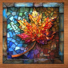 a stained glass window with a colorful leaf on it's side, in the shape of a mosaic