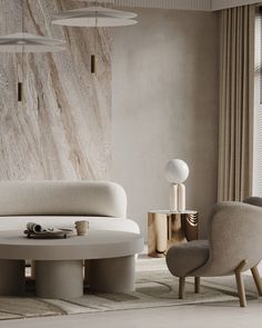 a living room with two chairs and a round table in front of a marble wall