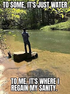 a man standing on top of a rock next to a river