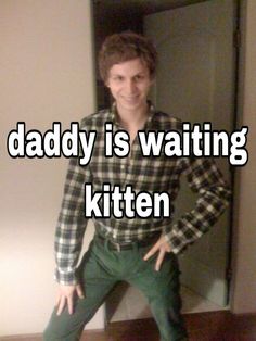 a man standing in front of a mirror with the words daddy is waiting kitten