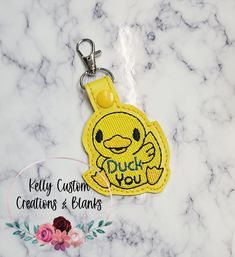 a yellow keychain with the words pick you on it and an emoticive smiley face