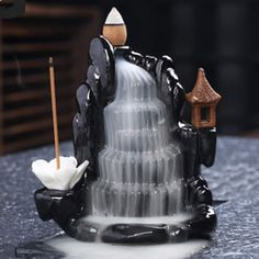 a black and white cake sitting on top of a table next to a candle holder