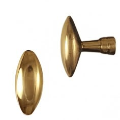 two gold colored metal knobs on a white background