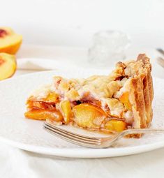 a slice of peach pie on a plate with a fork