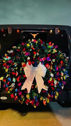 a decorated christmas wreath on the back of a bus