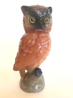 an owl figurine sitting on top of a rock