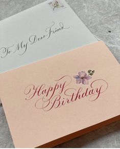 two cards with the words happy birthday written on them, one has a flower in it