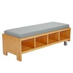 a wooden bench with two storage compartments on it's sides and a light blue seat cushion