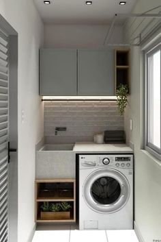 a washer and dryer in a small room with white tile flooring on the walls