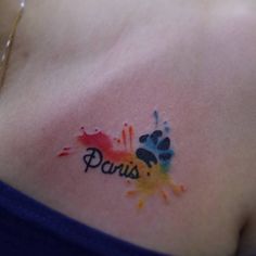 a woman's chest with the word paris painted on it and an animal paw