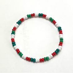 This bracelet is made with red, Emerald green, medium green and white size 6/0 (4mm) seed beads and is strung on high quality stretch cord. SIZE OPTIONS: - Small: 6.5 inches - Average: 7 inches - Medium/Large: 7.5 inches - Large: 8 inches - Extra Large: 8.5 inches CUSTOM: - I'm happy to create custom products. If you would like something different, please contact me. PROCESSING TIME: - Your bracelet will ship in 1-3 business days after purchase. CANADIAN ORDERS:  - FREE SHIPPING TO CANADA. Sent Bracelet Patterns Seed Beads, Red And Green Bracelet, Christmas Green Beaded Bracelets, Xmas Bracelet Ideas, White Beaded Stretch Bracelet For Holiday, Holiday White Beaded Stretch Bracelet, White Bracelets With Colorful Beads For Christmas, White Round Bead Bracelets For Holiday, Festive White Beaded Bracelets With Colorful Beads