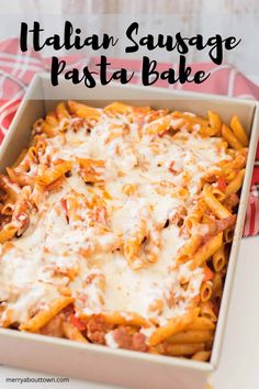 an italian sausage pasta bake in a baking dish with cheese and sauce on top