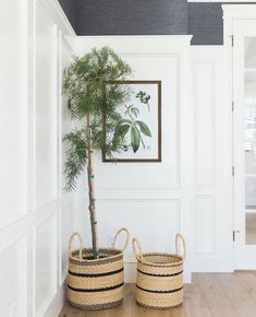 two baskets with plants in them on the floor