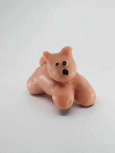 a small toy bear sitting on top of a white table