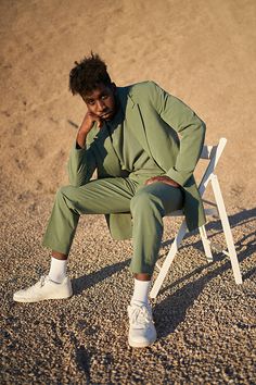 a man sitting in a chair on the beach