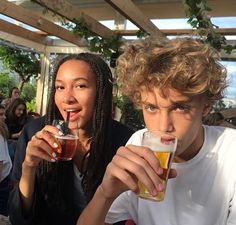 two people drinking beer at an outdoor event