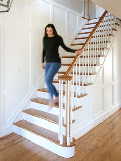 a woman walking up the stairs in a house