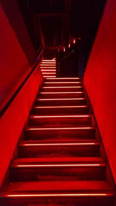 stairs lit up with red light in the dark