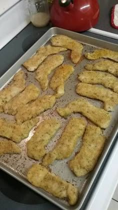 chicken strips on a baking sheet ready to go into the oven