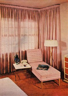 an old photo of a bedroom with pink curtains